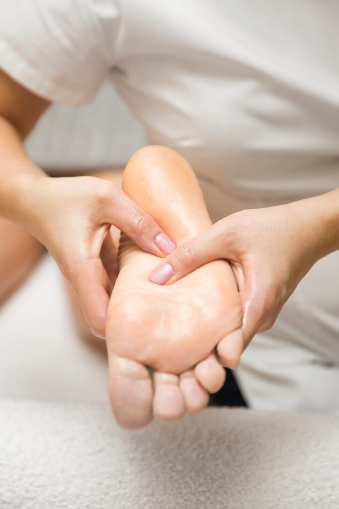 Woman receiving foot massage in spa salon